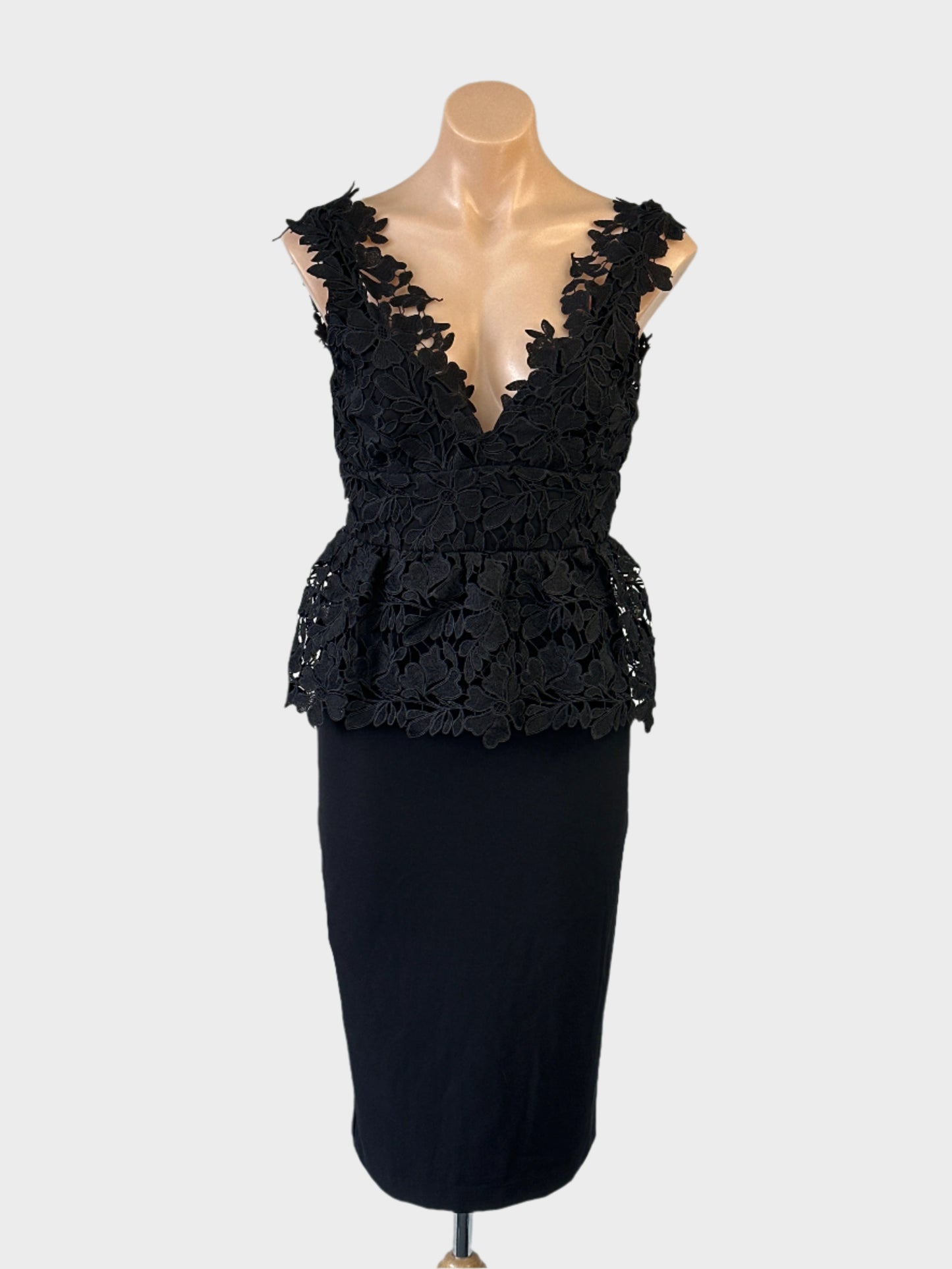 Bardot sleeveless peplum dress in black with guipure lace bodice and pencil skirt for evening or formal wear.