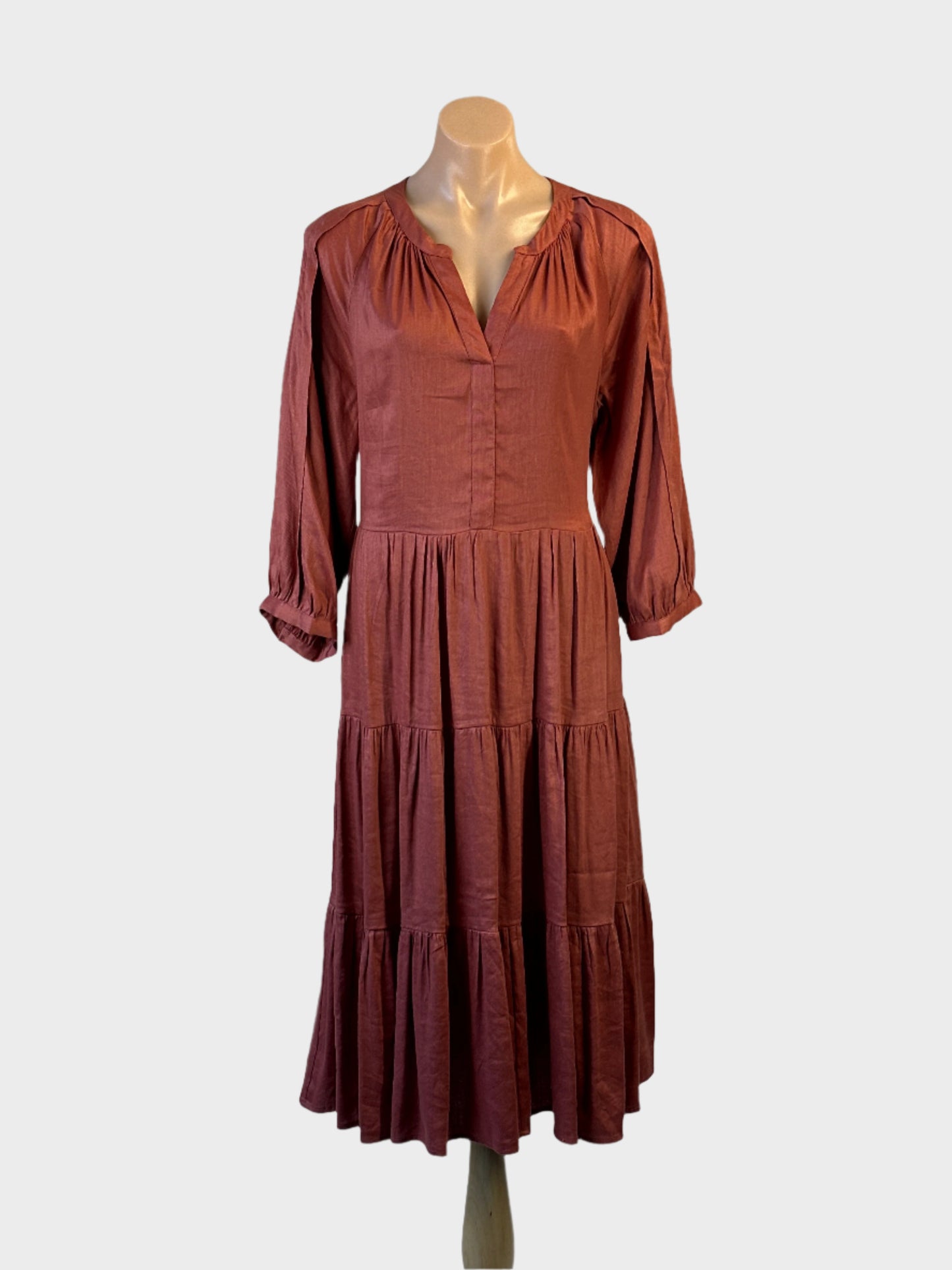 Basque brown linen blend smock dress with pleated sleeves and tie back waist for office or smart casual.