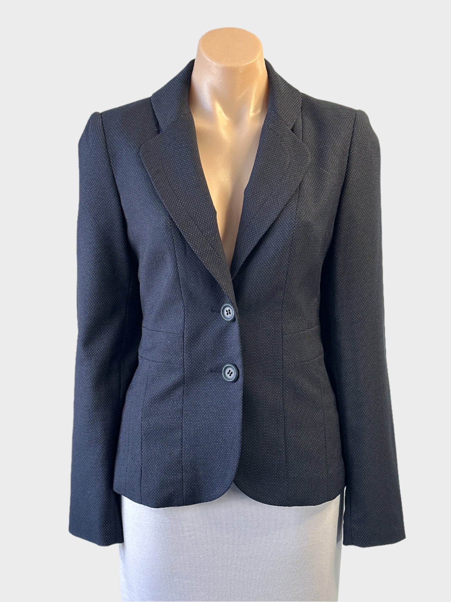 Basque single breasted jacket in navy blue and grey pin dot weave with back pleats for office wear.