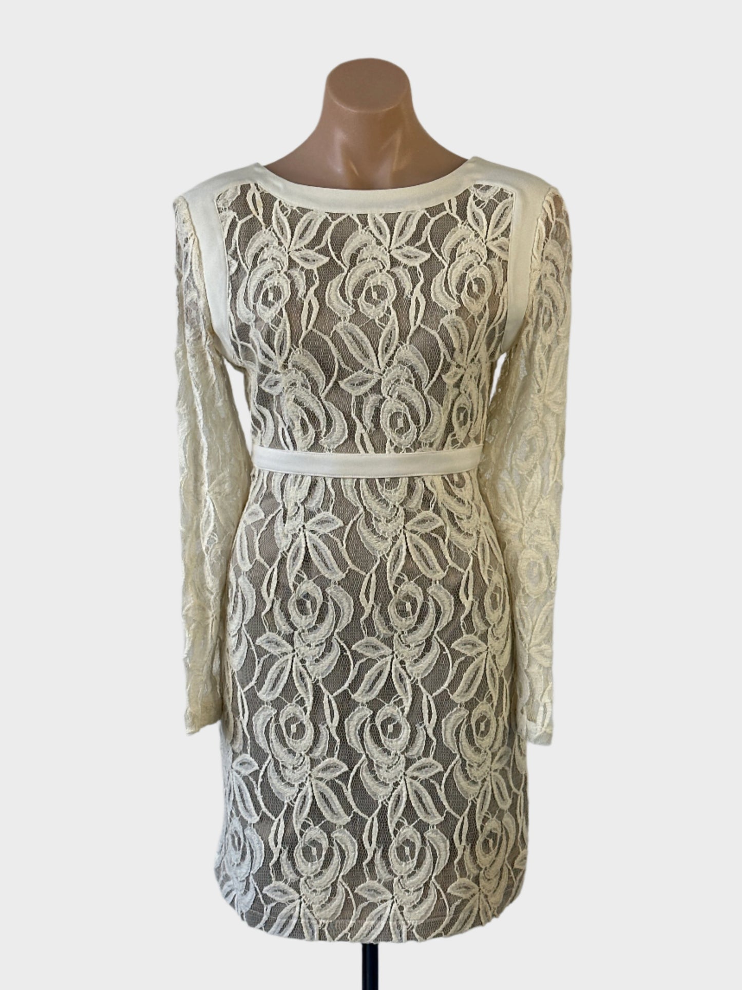 Designer bebe sheath dress in white sheer lace with woven trim, bateau neck and straight skirt for special events.
