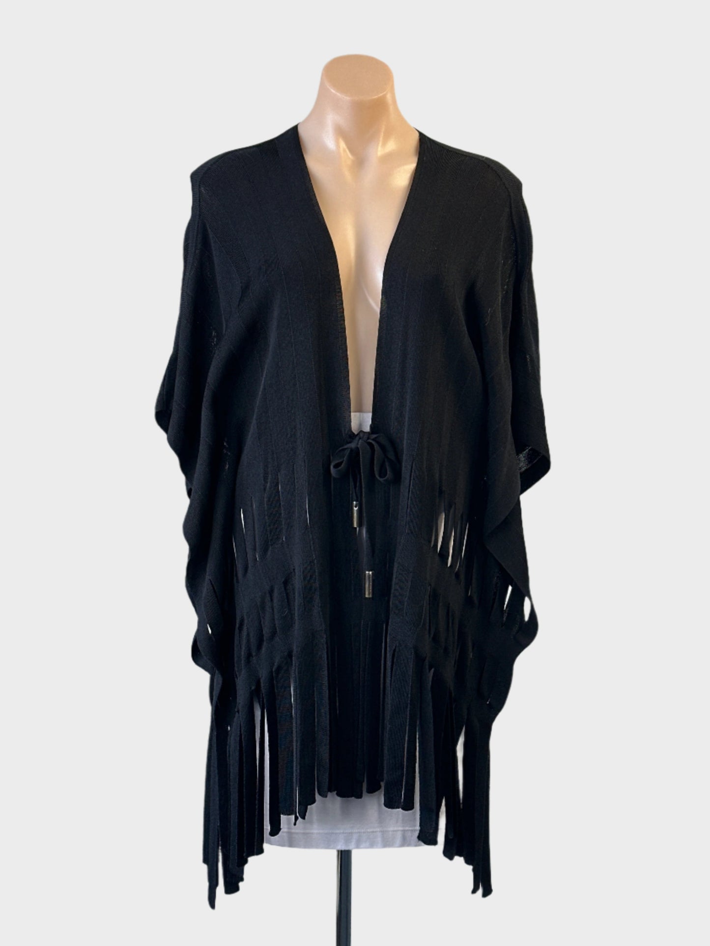 Designer Escada cape style vest in ribbed knit, featuring open front with self-tie fastening and long fringe hem.