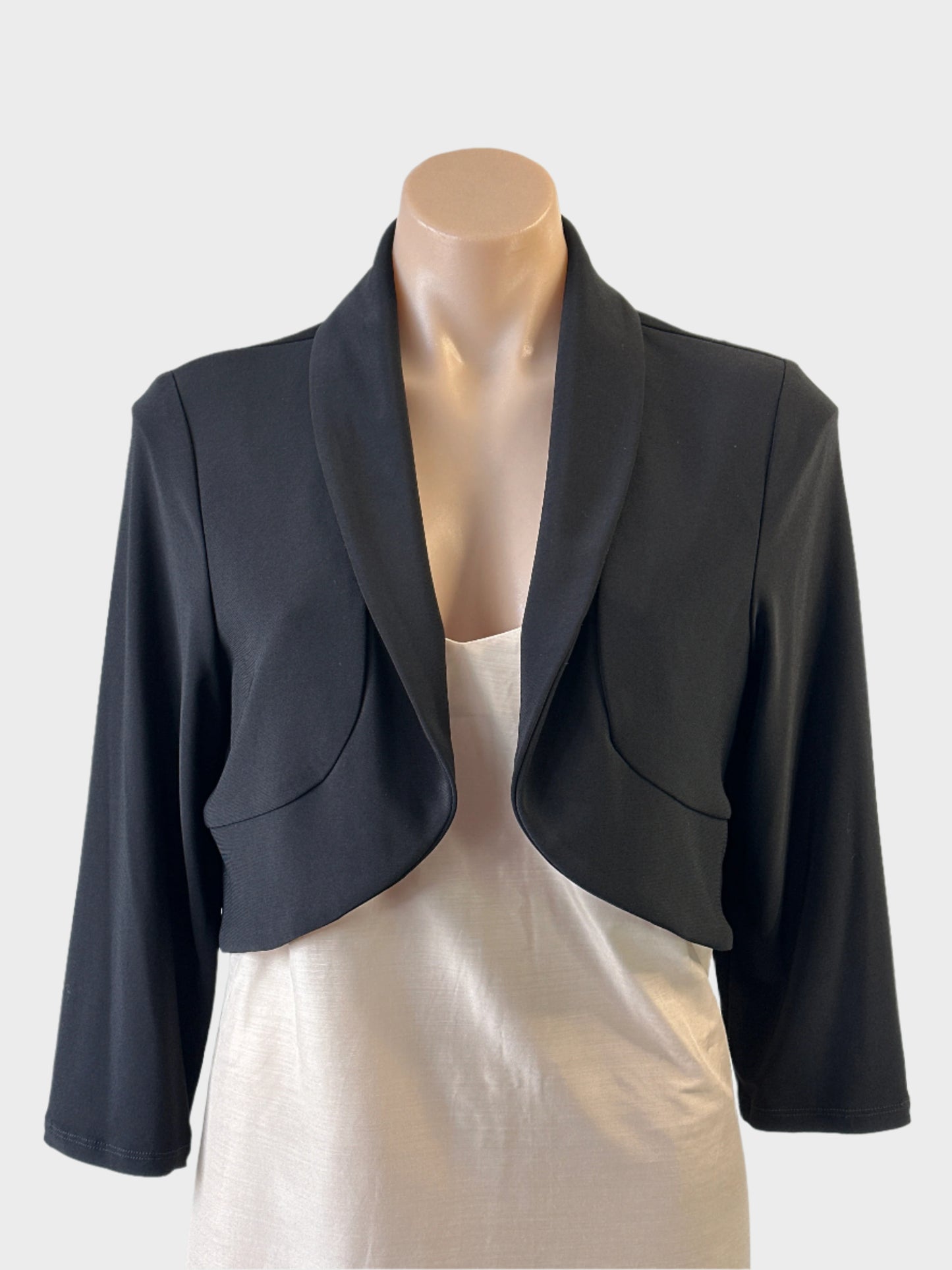 Designer Frank Lyman bolero jacket in black jersey with bow detail and shawl lapels for evening or formal wear.