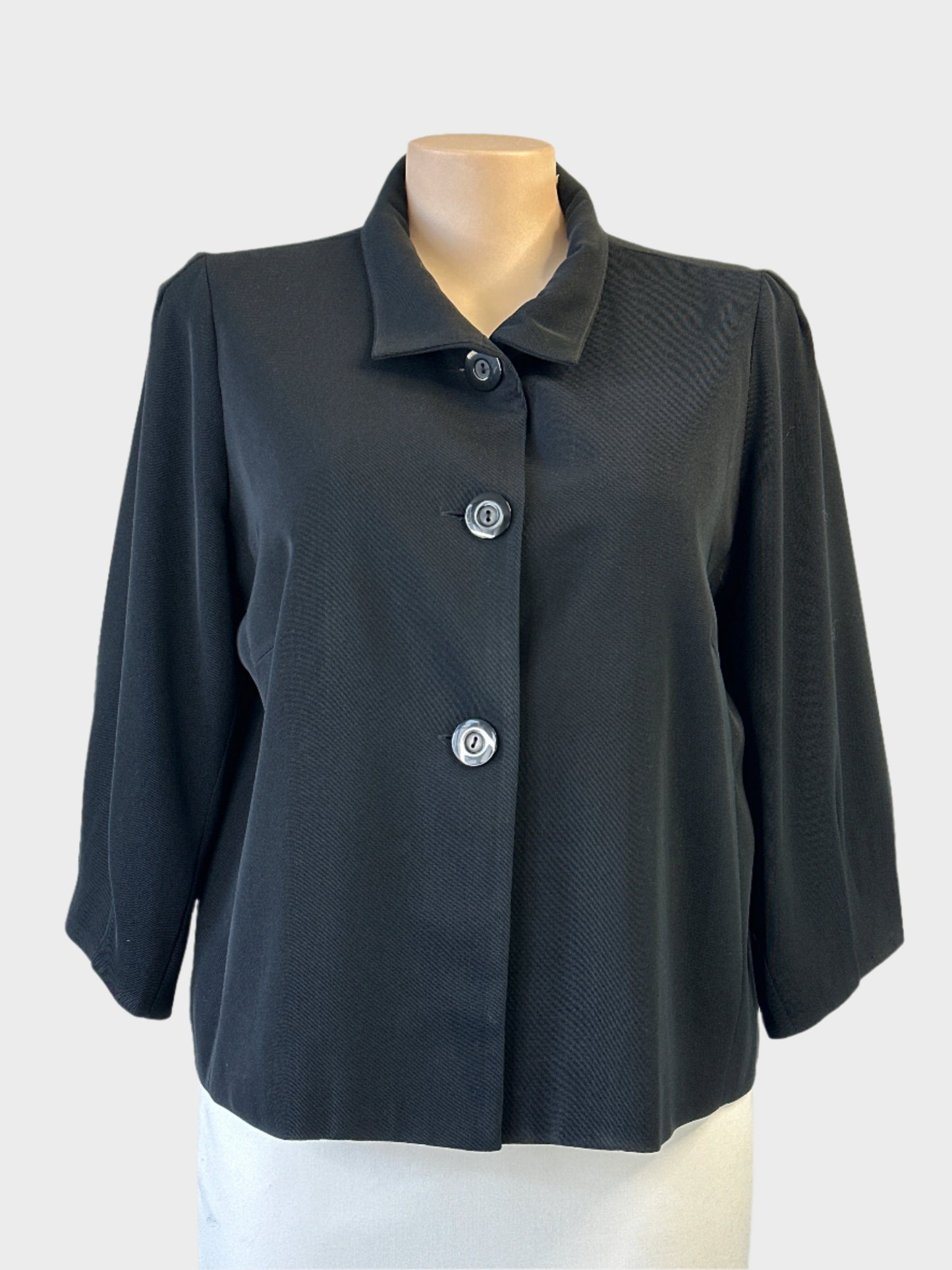Ignazia black single breasted jacket with convertible collar and three quarter sleeves for office wear.