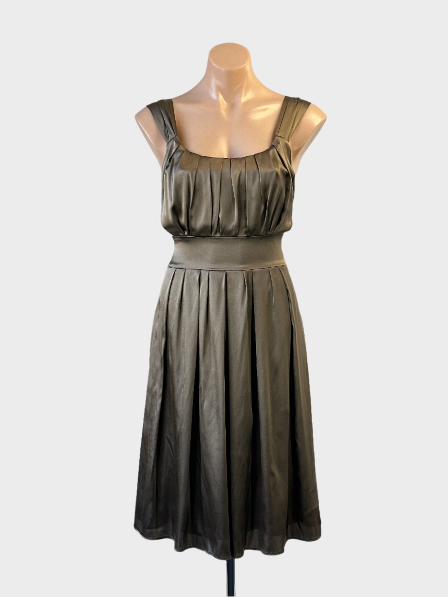 Designer Joseph sleeveless A-line dress in bronze satin finish with pleated bodice and sash for evening wear.