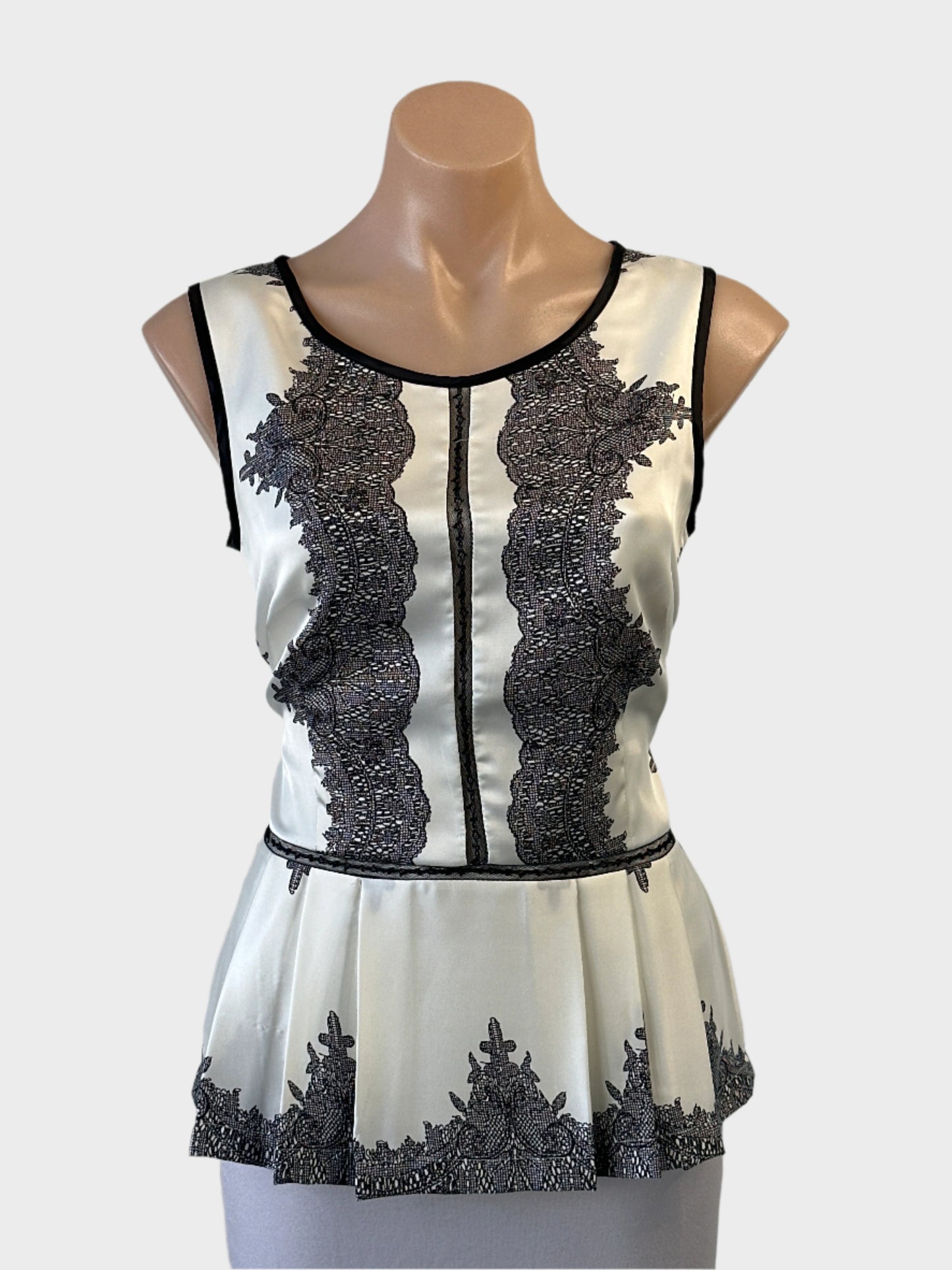 Designer Moss & Spy peplum top in black and white with lace inserts and satin finish for special events or office wear.