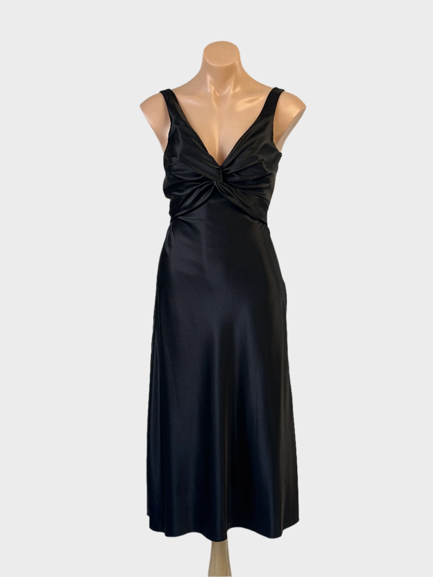 NOVITA bias cut dress in black with v-neck and tie back sash for formal or evening wear.