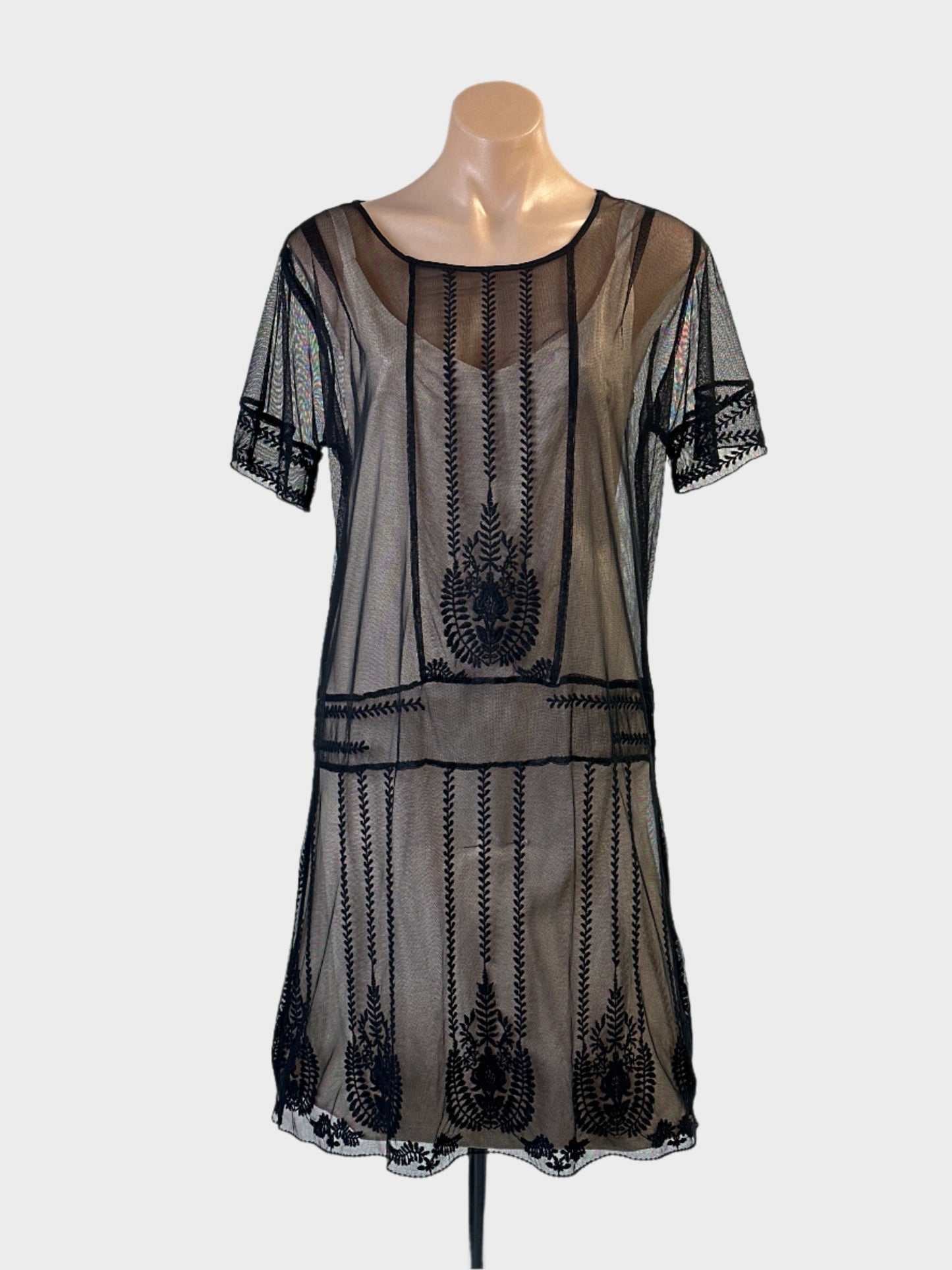 Retro 20's style black drop waist shift dress in sheer mesh with embroidered floral motifs for evening or special events.