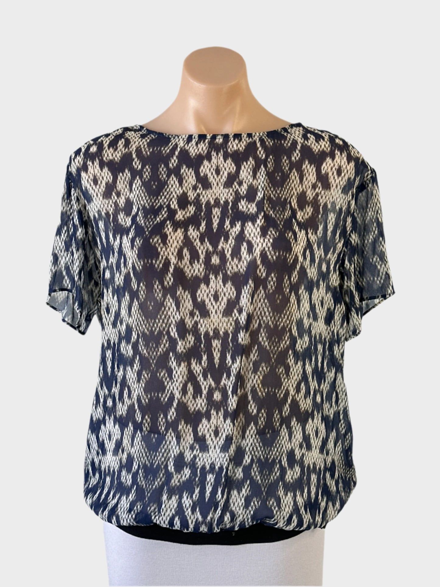Trussardi blouson top in blue ikat print sheer crepe with tie back and elastic hip band for office or smart casual wear.