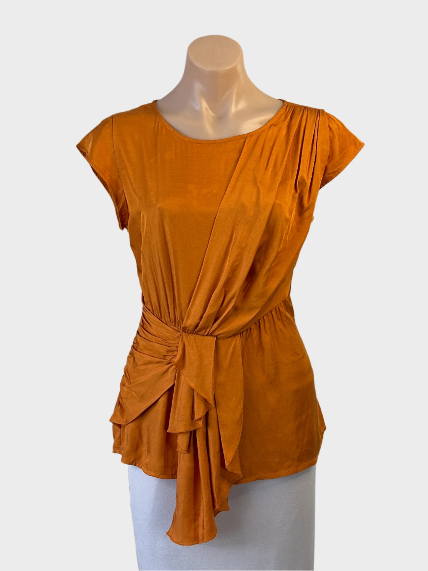 Veronika Maine peplum top in orange with cascading ruffle sash for office or smart casual wear.