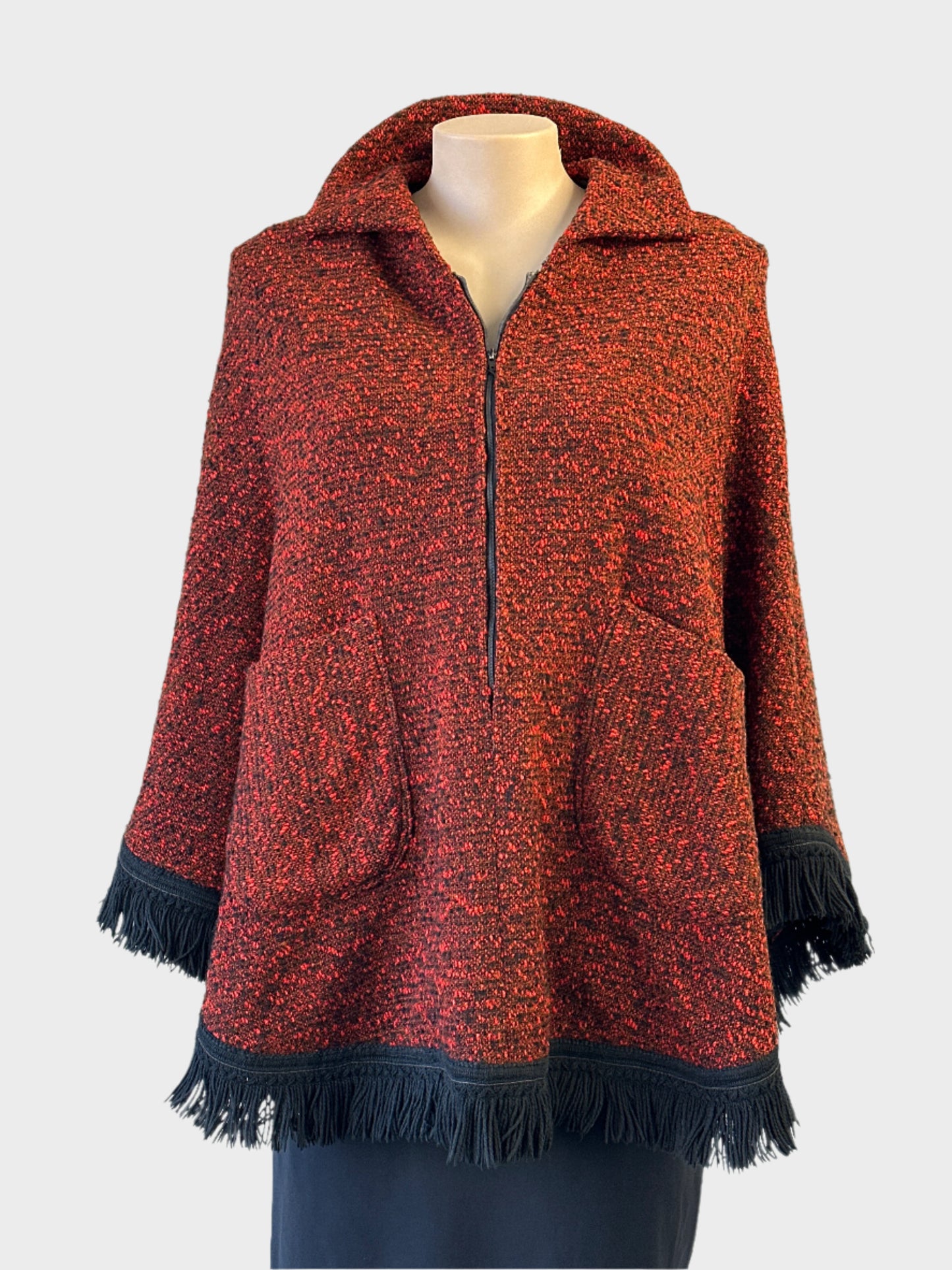 Vintage 60's poncho in black and red boucle wool with fringe trim for smart casual wear.