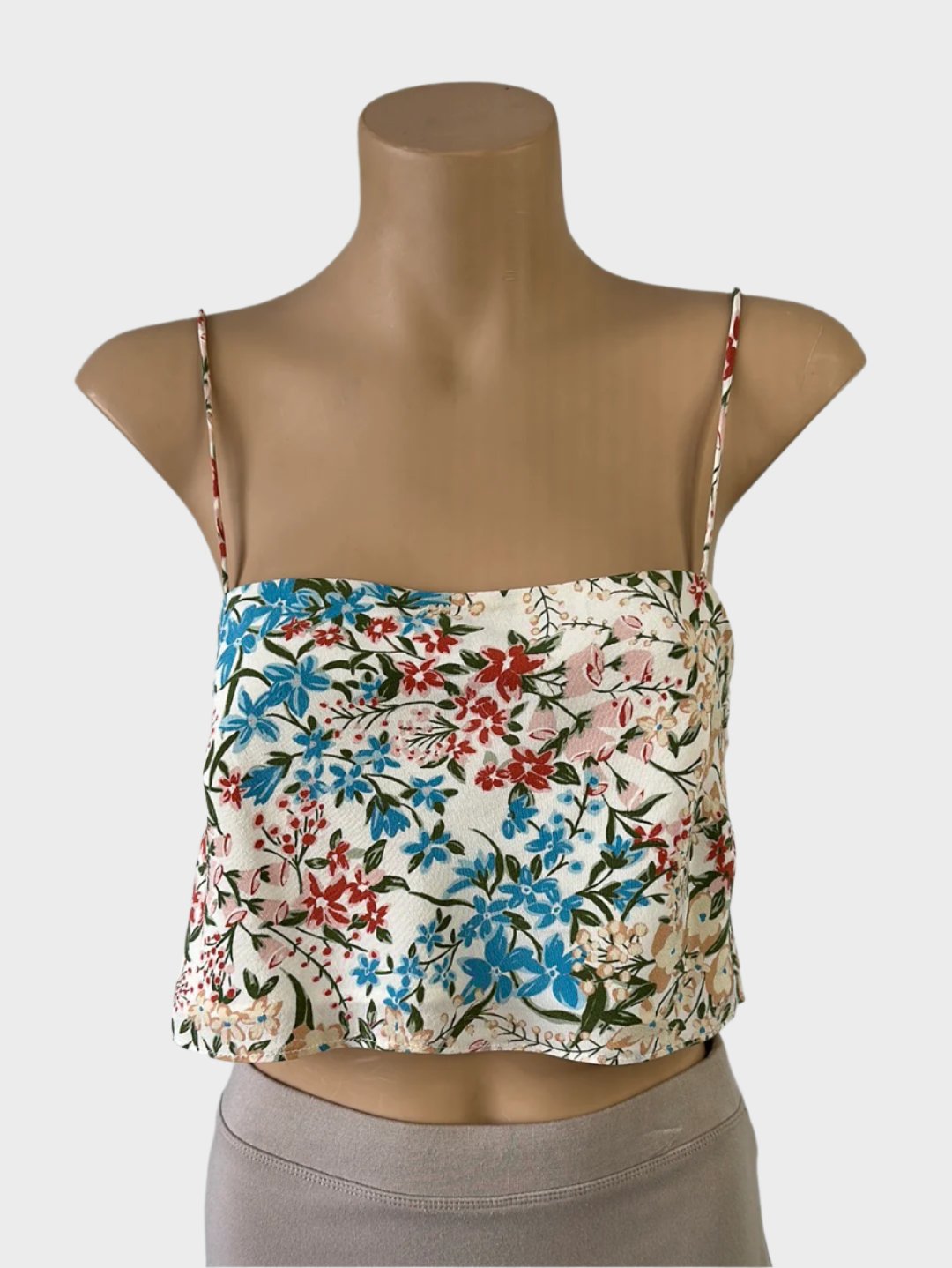 Designer Bec & Bridge sleeveless bralette top in cream and pink silk crepe with floral print, straight across neck, and spaghetti straps for resort wear.