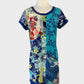 Orientique sleeveless shift dress in blue floral print with embroidery, scoop neck, cap sleeves, and skirt with in-seam pockets for resort wear.