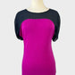 Armani Exchange designer jersey top in black and hot pink with sheer yoke, bateau neck, dolman sleeves, tab cuffs, for office or smart casual.