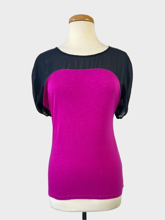 Armani Exchange designer jersey top in black and hot pink with sheer yoke, bateau neck, dolman sleeves, tab cuffs, for office or smart casual.