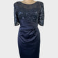 Designer Anthea Crawford sheath dress in blue satin with sequin overlay, illusion neck, ruched waist, and back vent for formal wear.