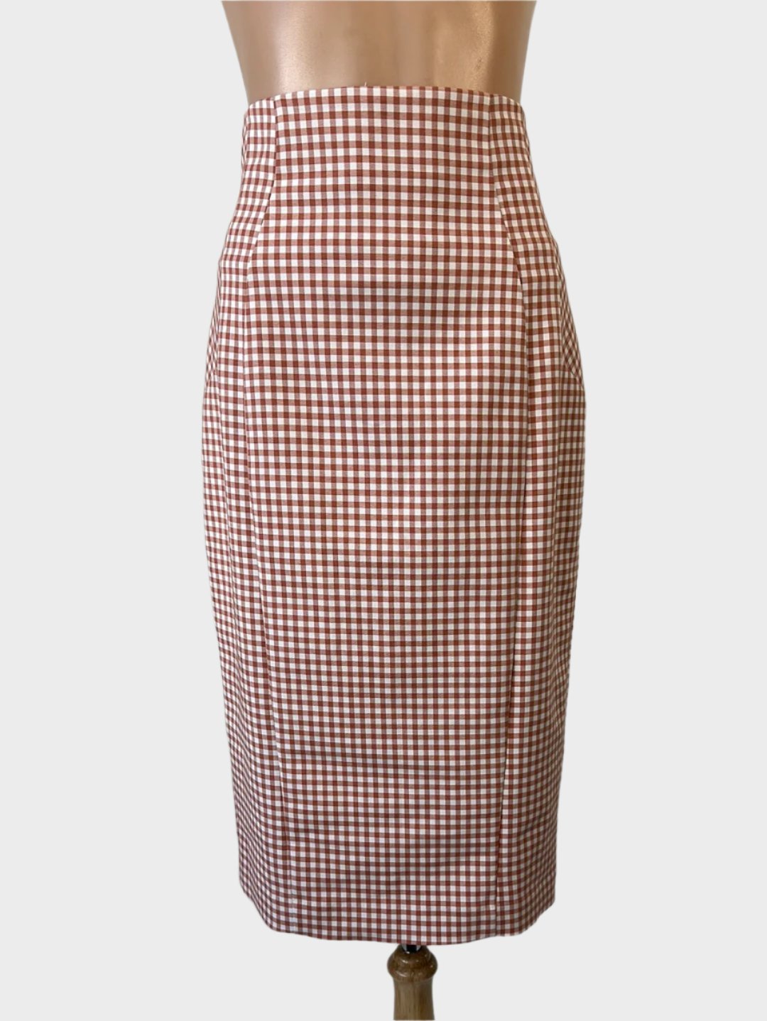 Cue classic pencil skirt in brown and white gingham with contour waist and back vent for office wear.