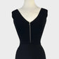 Portmans sleeveless peplum top in black rib knit with v-neck, v-shaped back, and zip front closure for evening wear.