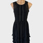 Designer Moiselle sleeveless black dress with illusion neck, pleated bows, frilled bib, keyhole back, and appliqué skirt for evening wear.