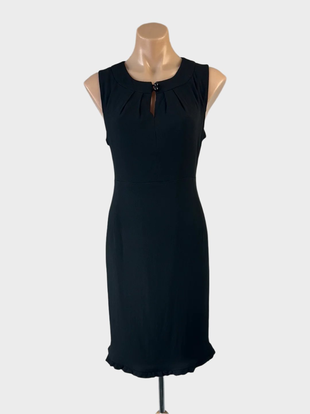 Designer Anna Thomas sleeveless sheath dress in black crepe with keyhole neck, ball button fasteners, and ruffle hem for office or evening wear.