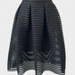 Designer Maje pleated A-line black skirt in sheer rib fabric with mini skirt underlay and narrow waistband for evening or formal wear.