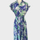 Vintage 60's A-line shirt dress in blue and green floral print with button-up front, notched collar, drop shoulders, waist sash, and pleated skirt for smart casual wear."