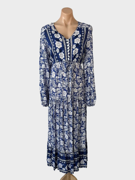 Boho style maxi dress in blue and white floral print with hummingbirds, featuring a contrasting bodice, v-neck, long sleeves, empire waist, and tiered skirt for casual wear.