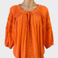 Country Road boho style top in orange cotton cheesecloth with folk art embroidery, notched neck, three quarter sleeves for smart casual or resort wear.