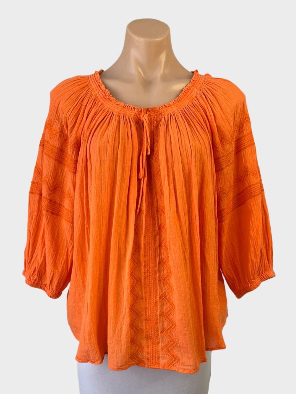 Country Road boho style top in orange cotton cheesecloth with folk art embroidery, notched neck, three quarter sleeves for smart casual or resort wear.