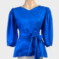 Vintage 80's peplum top in bright blue taffeta with v-neck, balloon sleeves, cummerbund waist sash, and pearl button back for evening wear.