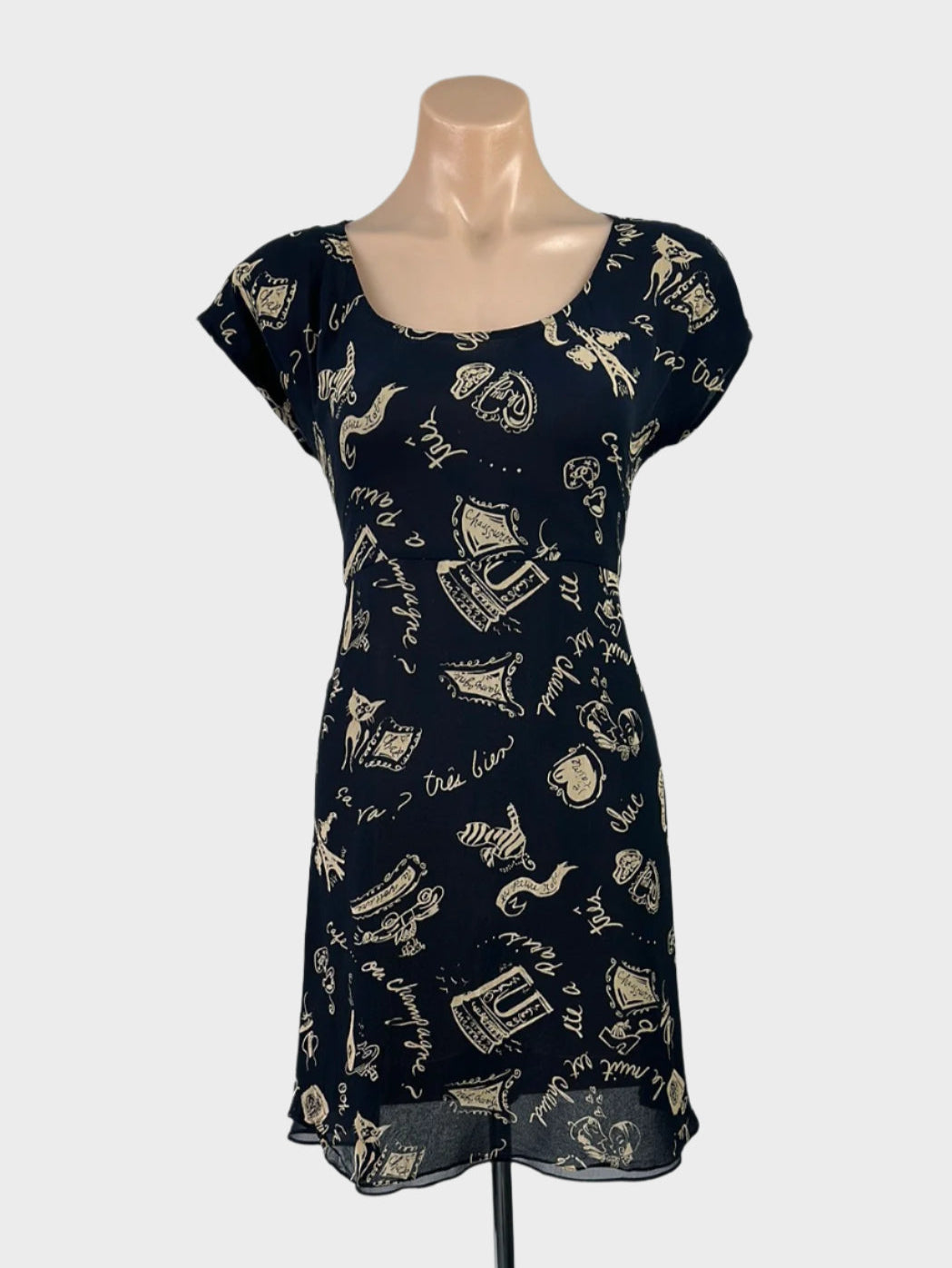 Designer DKNY A-line dress in sheer crepe with retro Parisian print, scoop neck, tie-back sash, and flared skirt for smart casual or office wear.