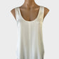 Designer sleeveless tank top in white satin finish with U-shaped neck, topstitch centre seam, and curved hem for office wear.