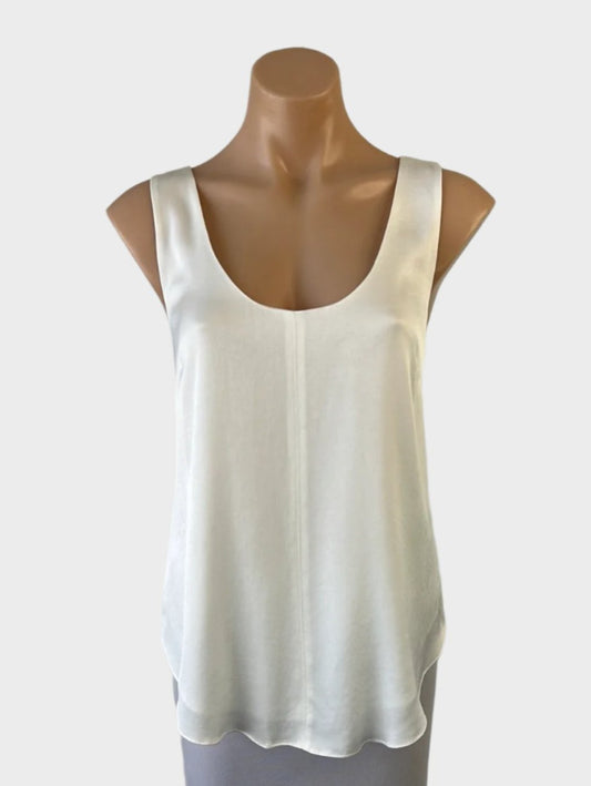 Designer sleeveless tank top in white satin finish with U-shaped neck, topstitch centre seam, and curved hem for office wear.