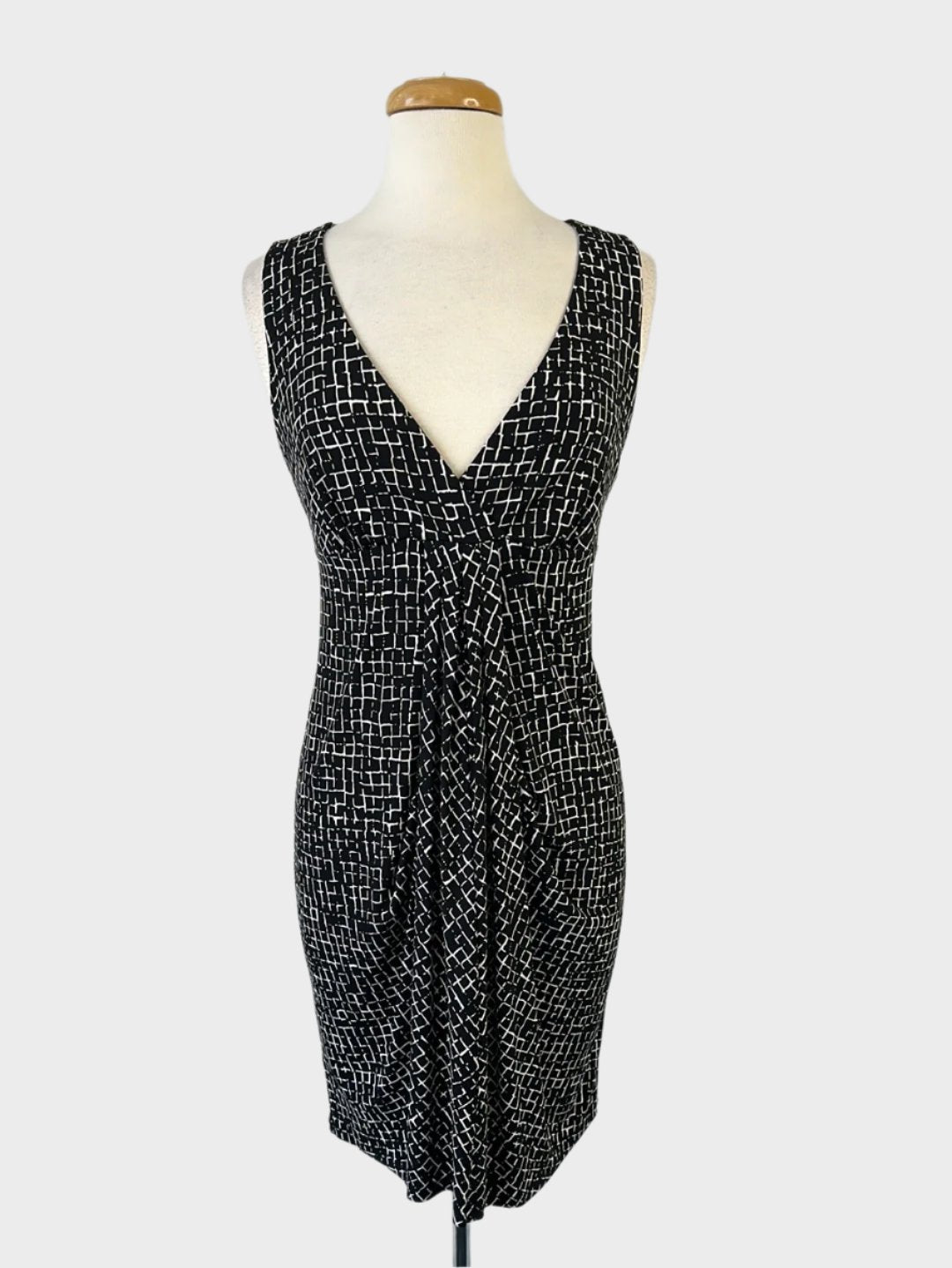 Ann Taylor designer empire waist jersey dress with fish net print, black and white, featuring a pleated skirt panel for office wear.