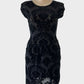 Designer FEATHERS shift dress in black sheer mesh with Baroque pattern flock appliqué, featuring bateau neck, drop shoulders, gathered waist, suitable for evening wear.