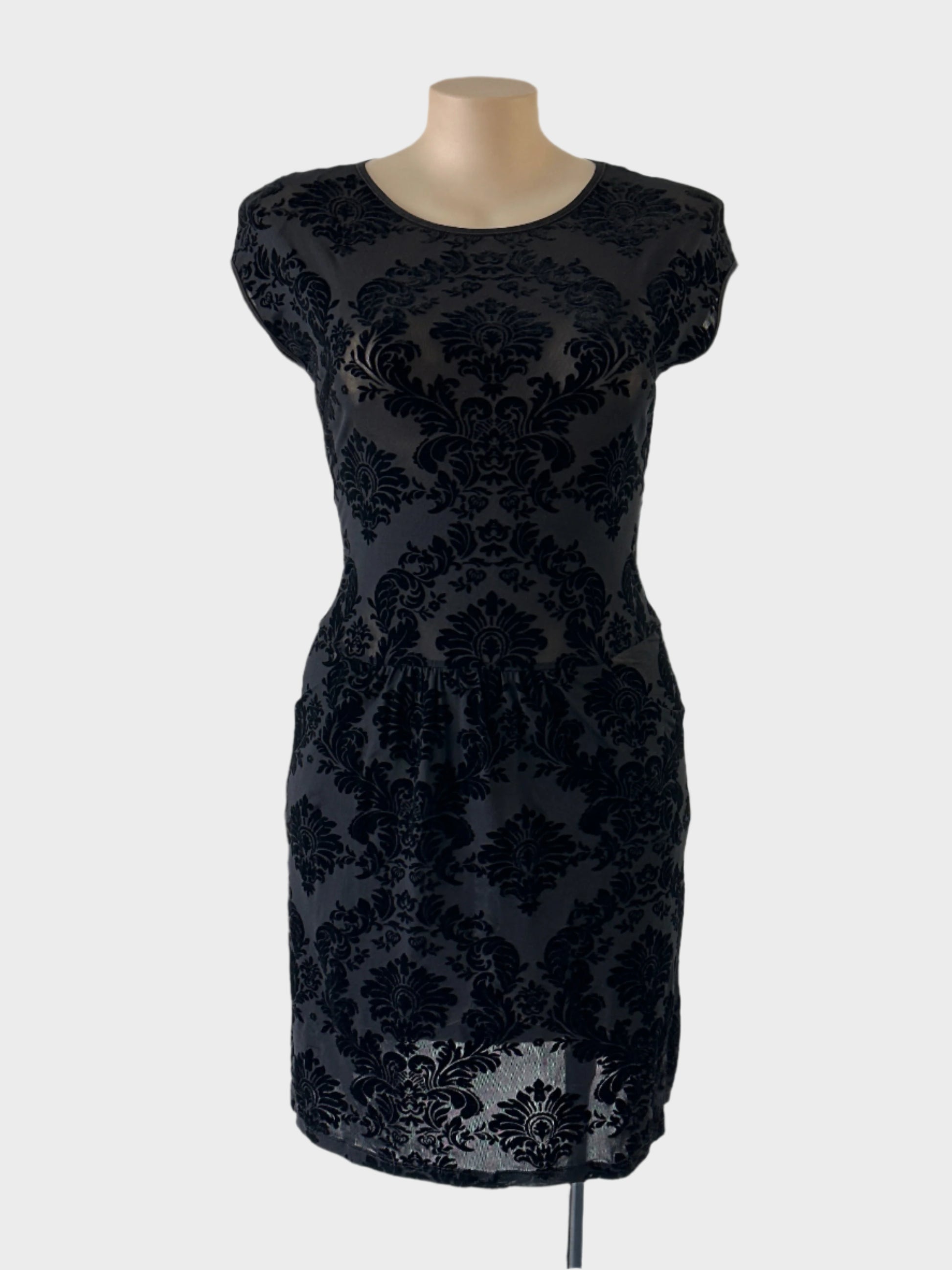 Designer FEATHERS shift dress in black sheer mesh with Baroque pattern flock appliqué, featuring bateau neck, drop shoulders, gathered waist, suitable for evening wear.