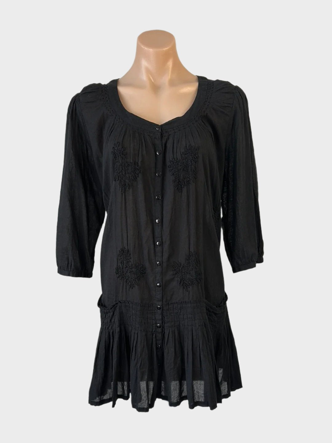 Designer Flower Boho style shirt dress in black cotton with floral embroidery, scoop neck, drop waist, and pleated skirt for smart casual wear.