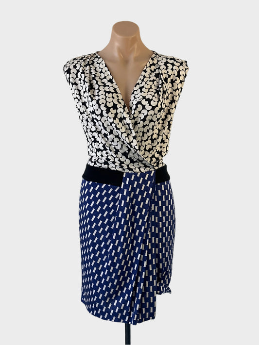 Designer Diane von Furstenberg sheath dress in black and white jersey with geometric prints, surplice neck and tulip skirt for office wear.