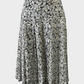 Designer Akira Isogawa vintage 90's pleated skirt in white and silver sheer silk crepe with Japanese floral print, metallic finish, and asymmetric yoke waist for evening wear.