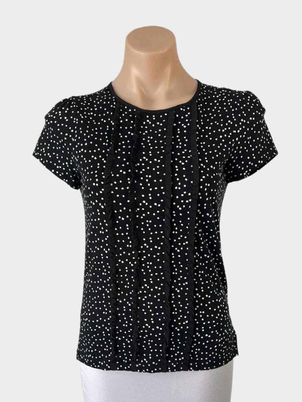 Marks top in jersey with black and white dot print, frilled trim, round neck, cap sleeves for office or smart casual.