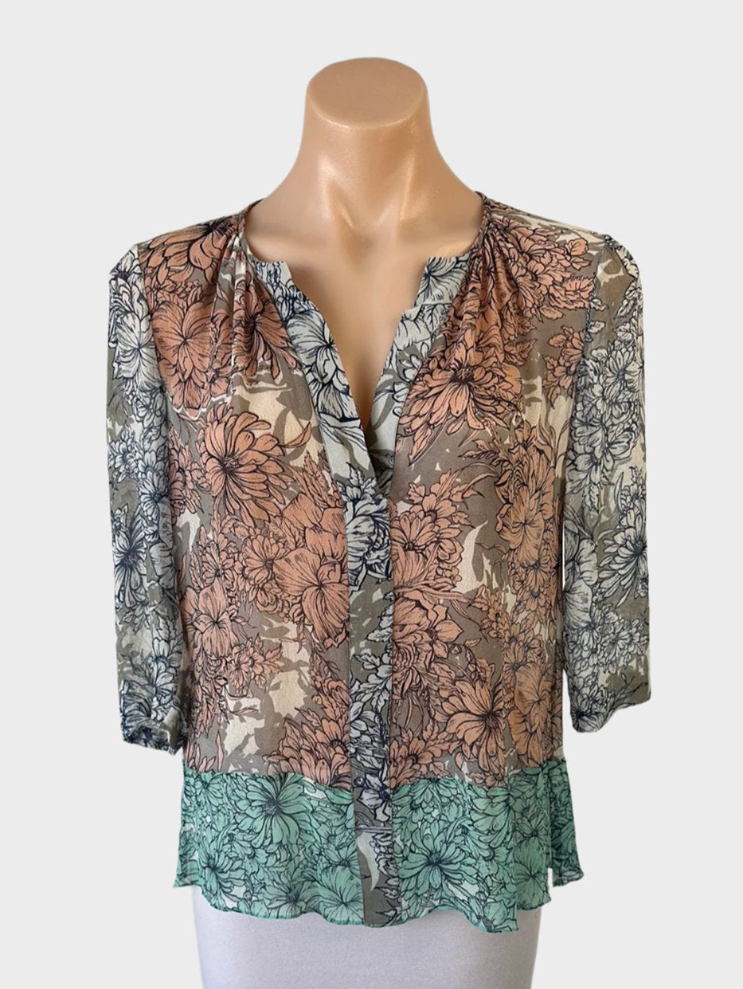 Designer Megan Park top in multicoloured sheer crepe with floral print, notched neck, three-quarter sleeves, and contrasting hem for smart casual wear.