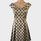 Review-A-line dress in gold and black with polka dot print, bateau neck and pleated skirt for evening or smart casual.