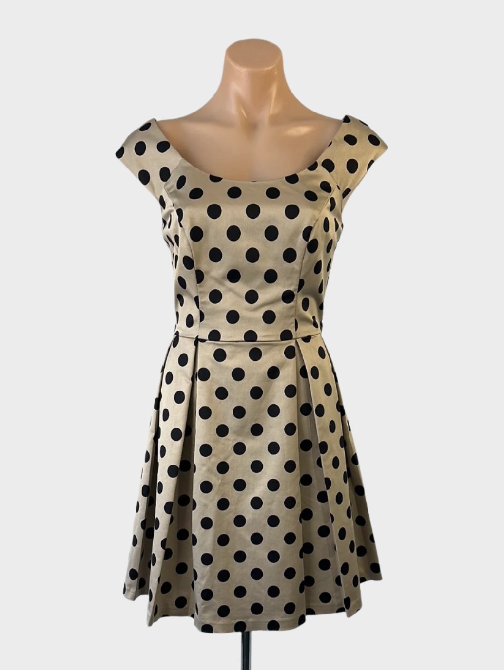 Review-A-line dress in gold and black with polka dot print, bateau neck and pleated skirt for evening or smart casual.