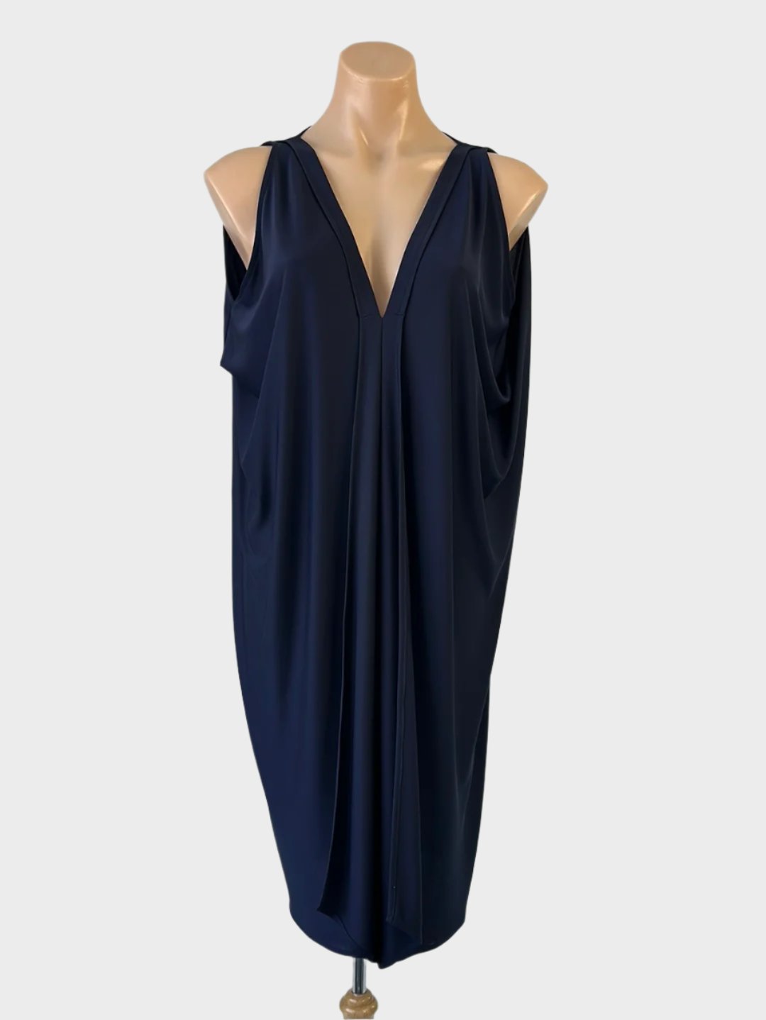 Designer Sacha Drake classic cocoon dress in navy blue jersey with draped sides, v-neck, and cascading flounce for office or evening wear.