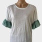 Seed top in white and green pure linen jersey with round neck and contrasting striped ruffle cuffs for smart casual or resort wear.