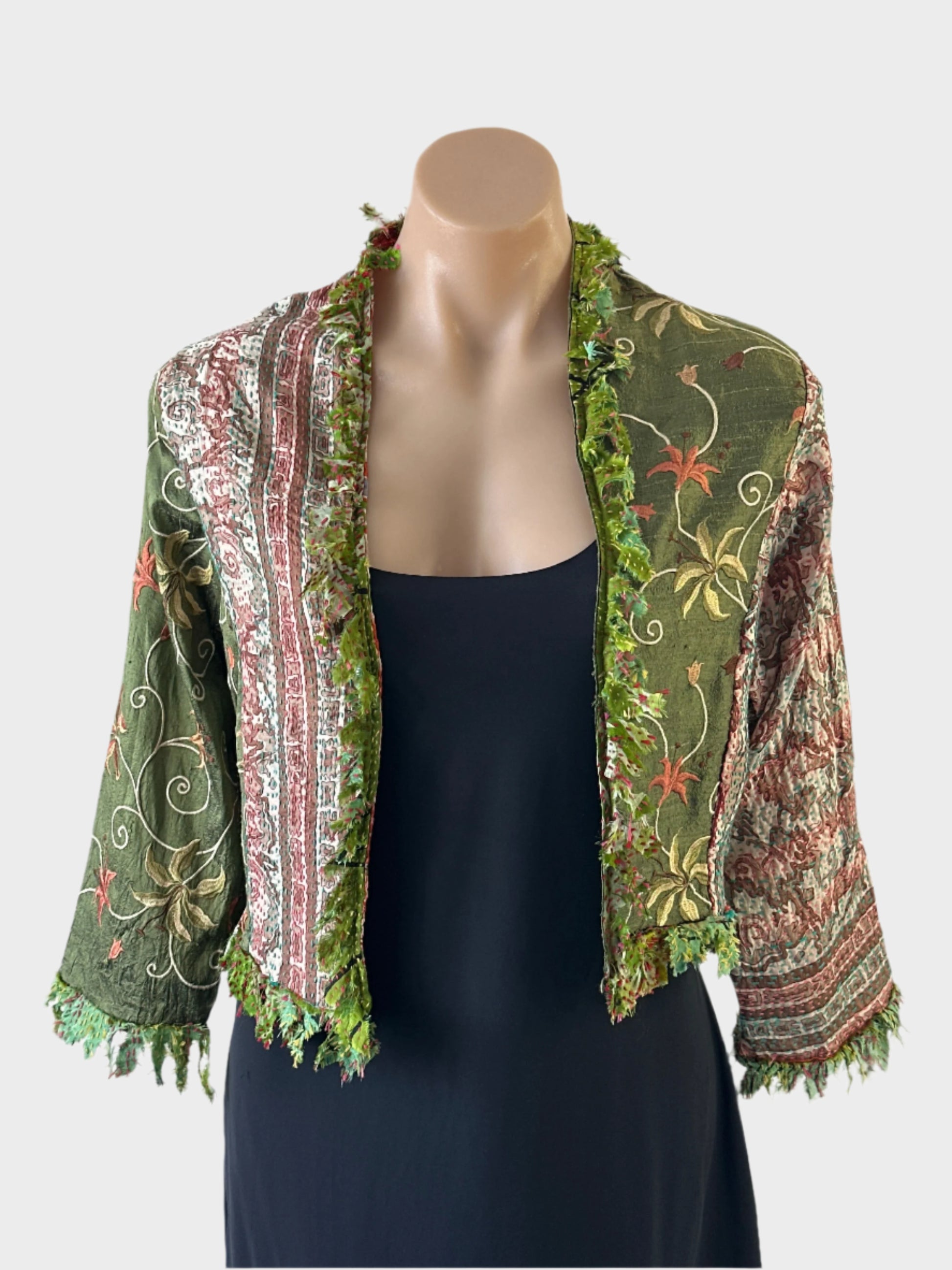 Designer Silver Cocoonz boho style open front cardigan jacket in green pure silk, featuring fringe trim, floral embroidery, and three quarter sleeves for events or smart casual occasions.