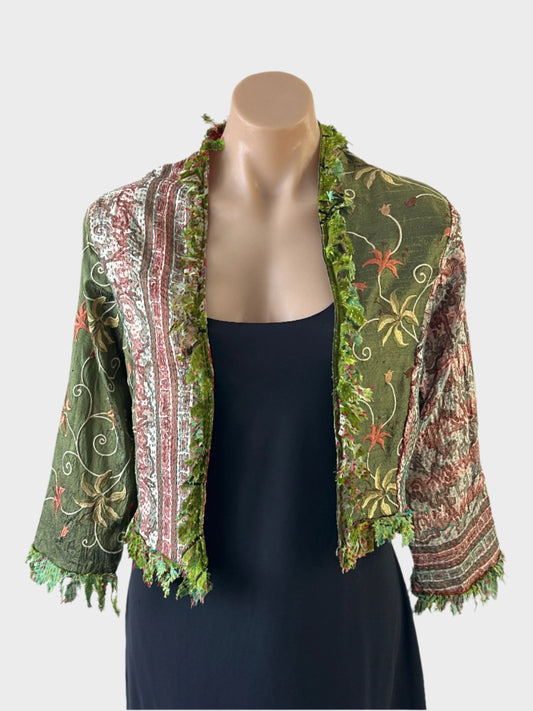 Designer Silver Cocoonz boho style open front cardigan jacket in green pure silk, featuring fringe trim, floral embroidery, and three quarter sleeves for events or smart casual occasions.