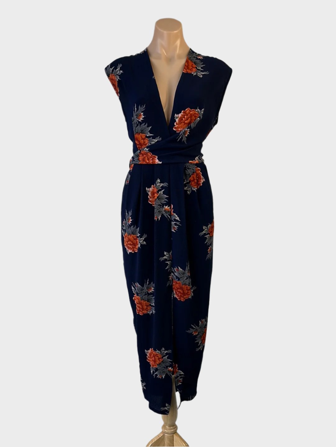 Sleeveless sheath dress in crepe with navy and orange floral print, featuring a surplice neck, pleated pencil skirt with slash pockets, and front split for evening wear.