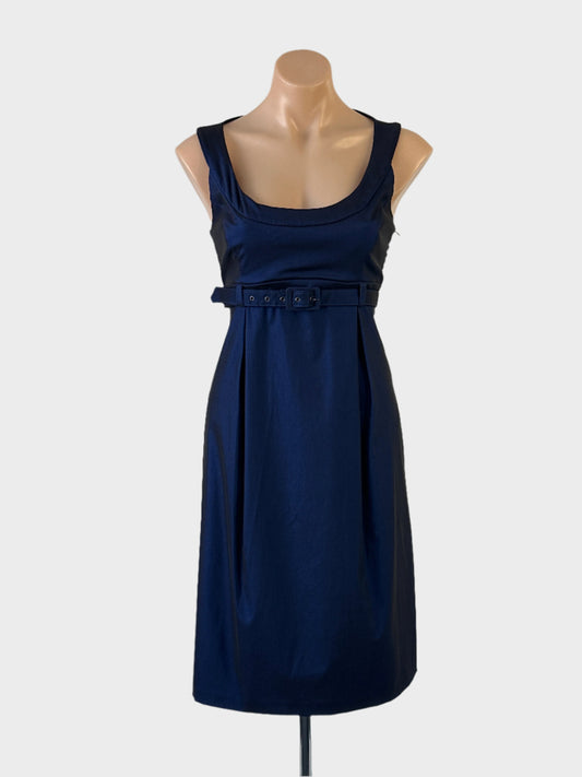 Designer Cue sleeveless empire waist dress in blue with sheen finish, D-shaped neck, matching skinny belt and gently flared pleated skirt for evening.