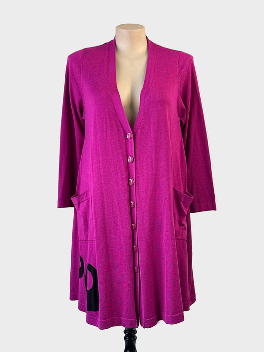 Taking shape long line cardigan in a hot pink rib knit with contrasting circle motifs, featuring a button up front, long sleeves and front patch pockets for casual or office wear.