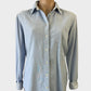 Designer Tommy Hilfiger denim shirt in light wash with striped cuffs, patch pocket, and curved hem for smart casual wear.